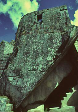 Machu Picchu Torreon is perched on an immense rock and above a small cave.