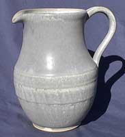 White stoneware pitcher  glazed by dipping.