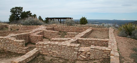 Escalante Pueblo kiva is surrounded by a room block. Note Mt. Wilson and the Rocky mountains.
